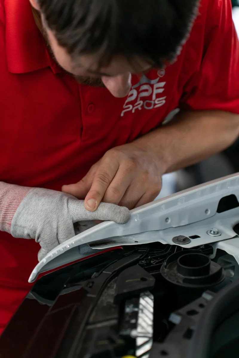 Paint protection film being installed on a vehicle hood